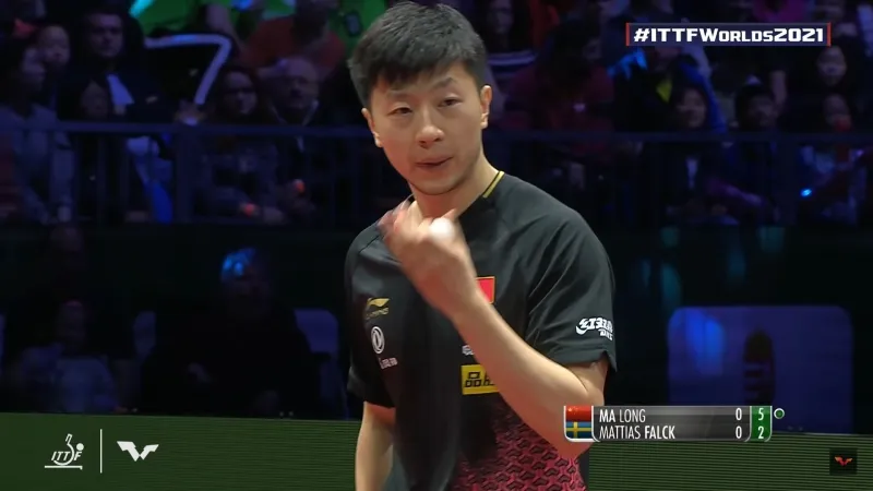 A picture of a player blowing on the ball to remove most of the moisture from it.