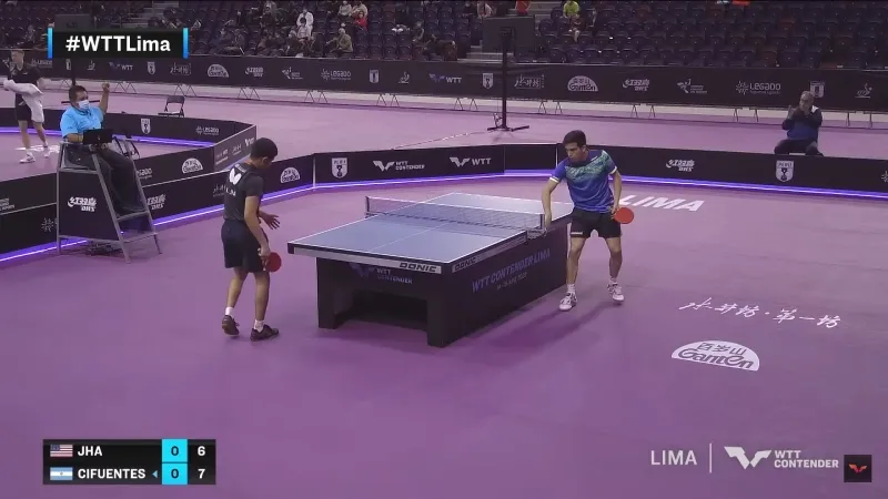 A picture a player drying his hands on the side of the table.