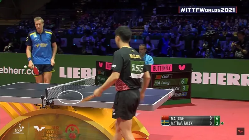 A picture of a player drying his hands on the table.