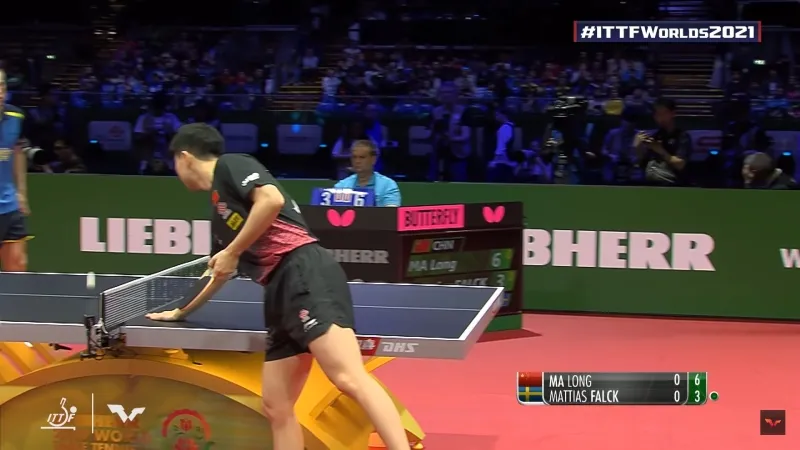 A picture of a player drying his hands on the table.