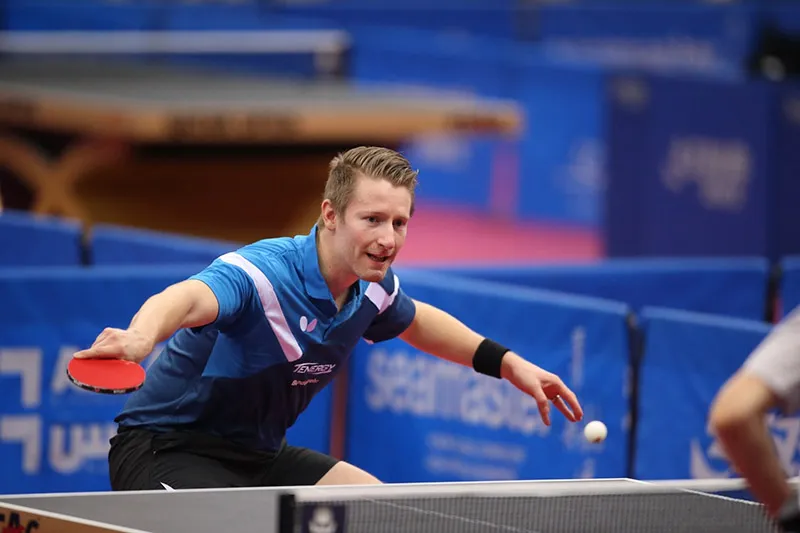 A picture of Matthias Falck defending in Table Tennis