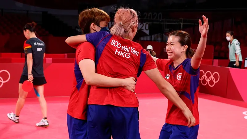 Hong Kong women's table tennis team members Doo Hoi Kem, Soo Wai Yam and Lee Ho Ching celebrating at the Tokyo 2020 Olympic Games