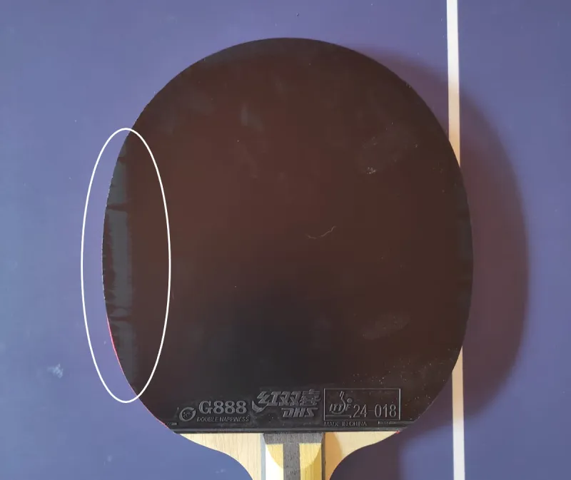 A picture of the imperfection in the backhand rubber that never came off, and lots of stains along the rubber.