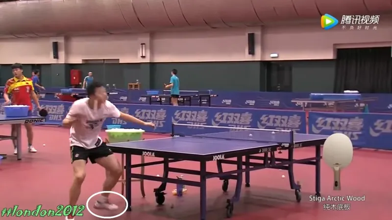 A picture of Ma Long practicing serves.