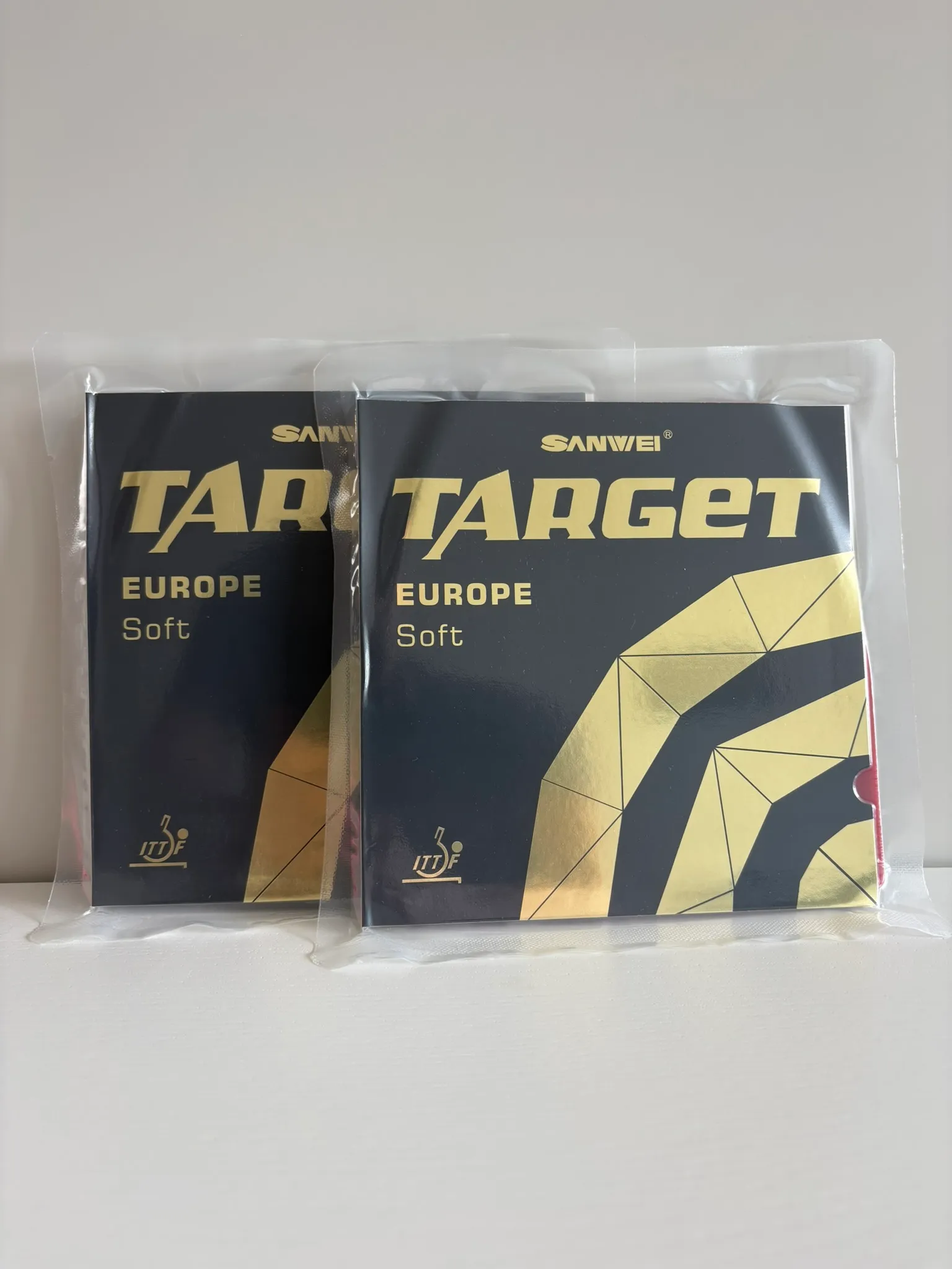 Front of two sealed Sanwei Target Europe Soft rubber packages with gold and black cover artwork.