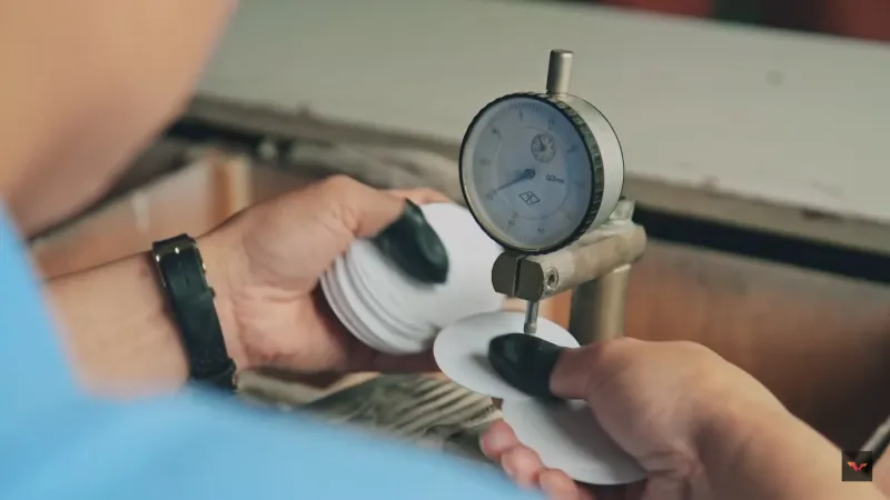 A picture of Someone checking a plastic sheet.