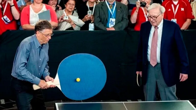 Warren Buffet and Bill Gates playing Table Tennis with a giant racket.